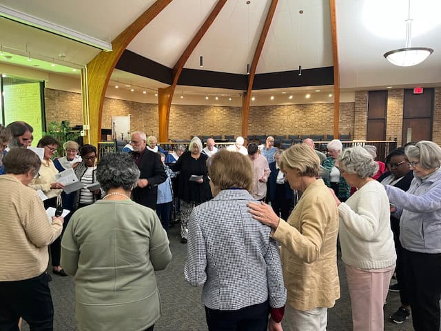 Congregation gathered in John Calvin Presbyterian Church for prayer and worship.