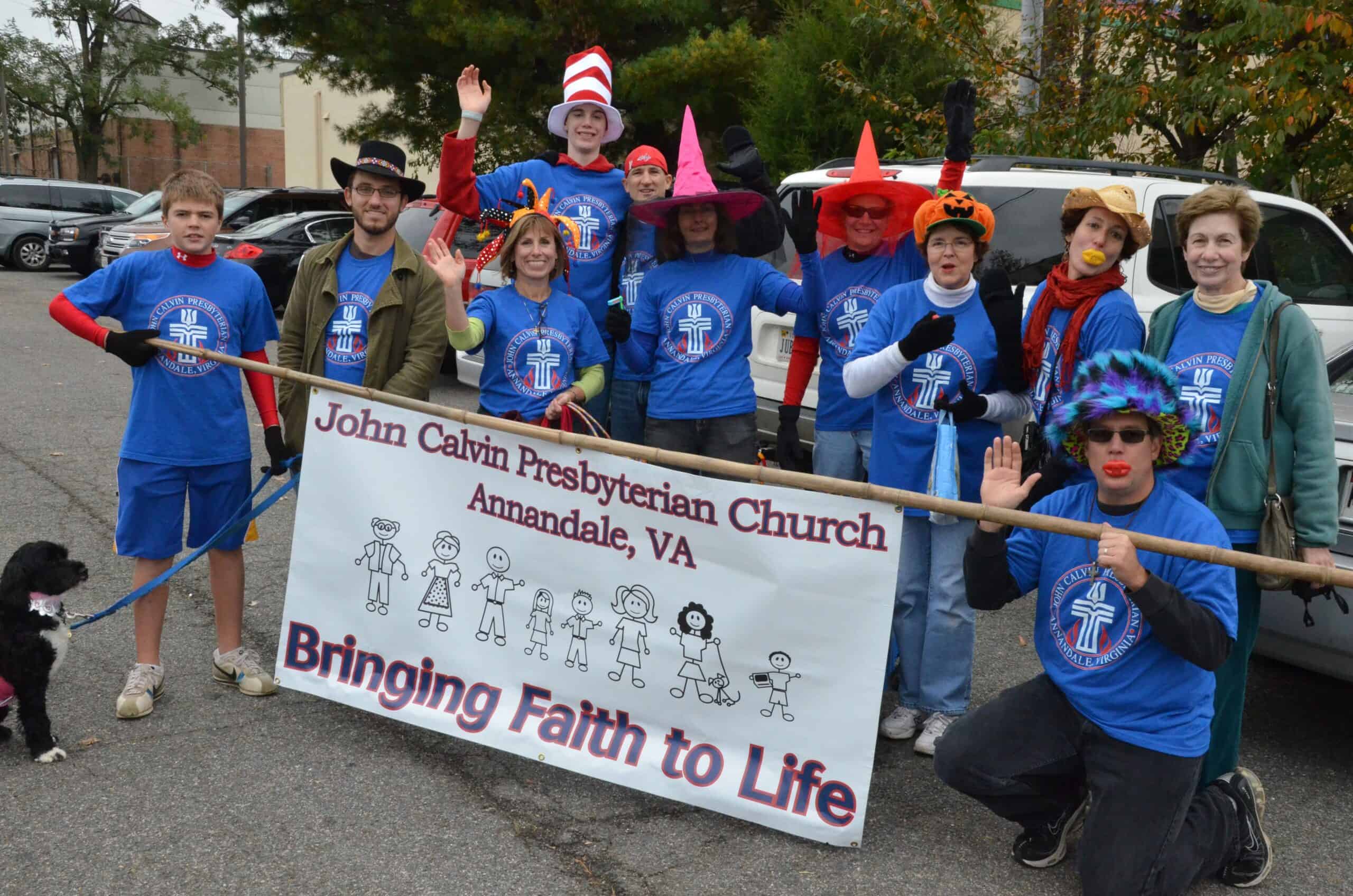 John Calvin Presbyterian Church parade with community gathering and banner in Annandale, VA.